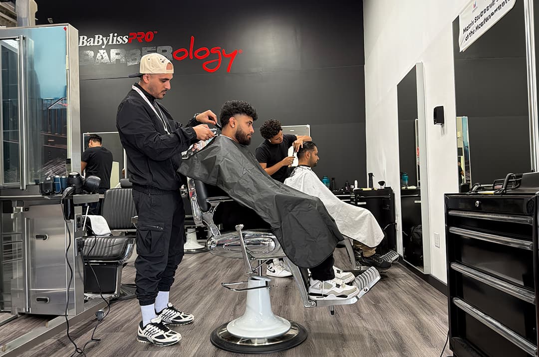 Beauty and barbering students training in a salon at Marca College as part of scholarship-supported education